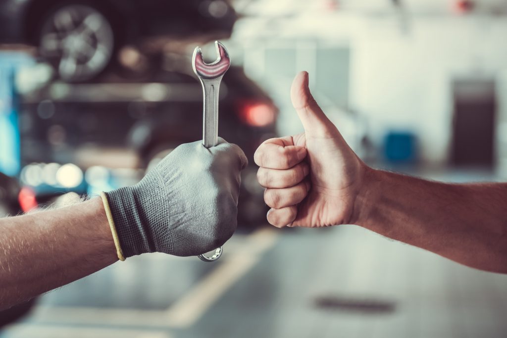 car mechanic doing a thumbs up
