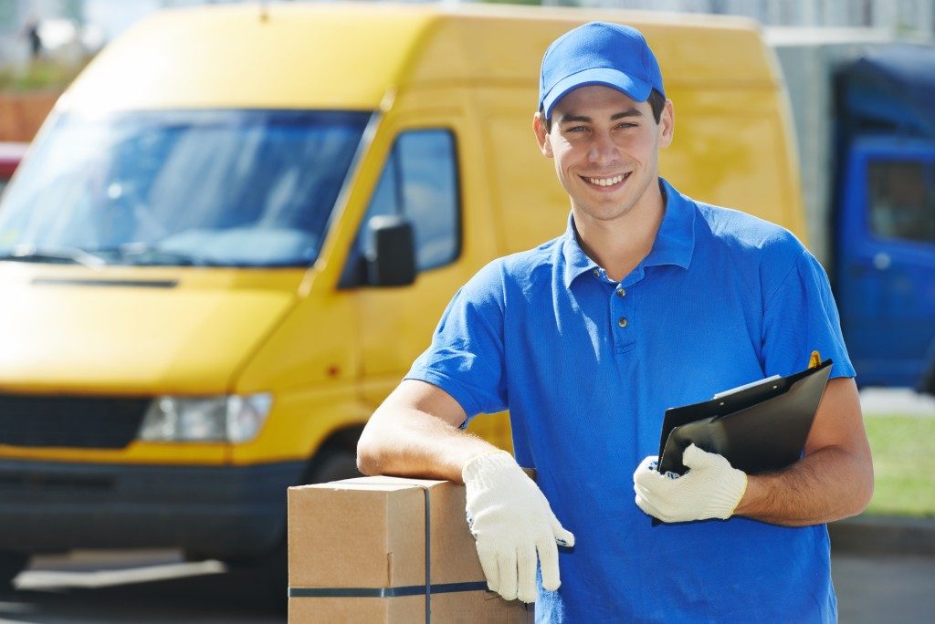 smiling man holding a parcel